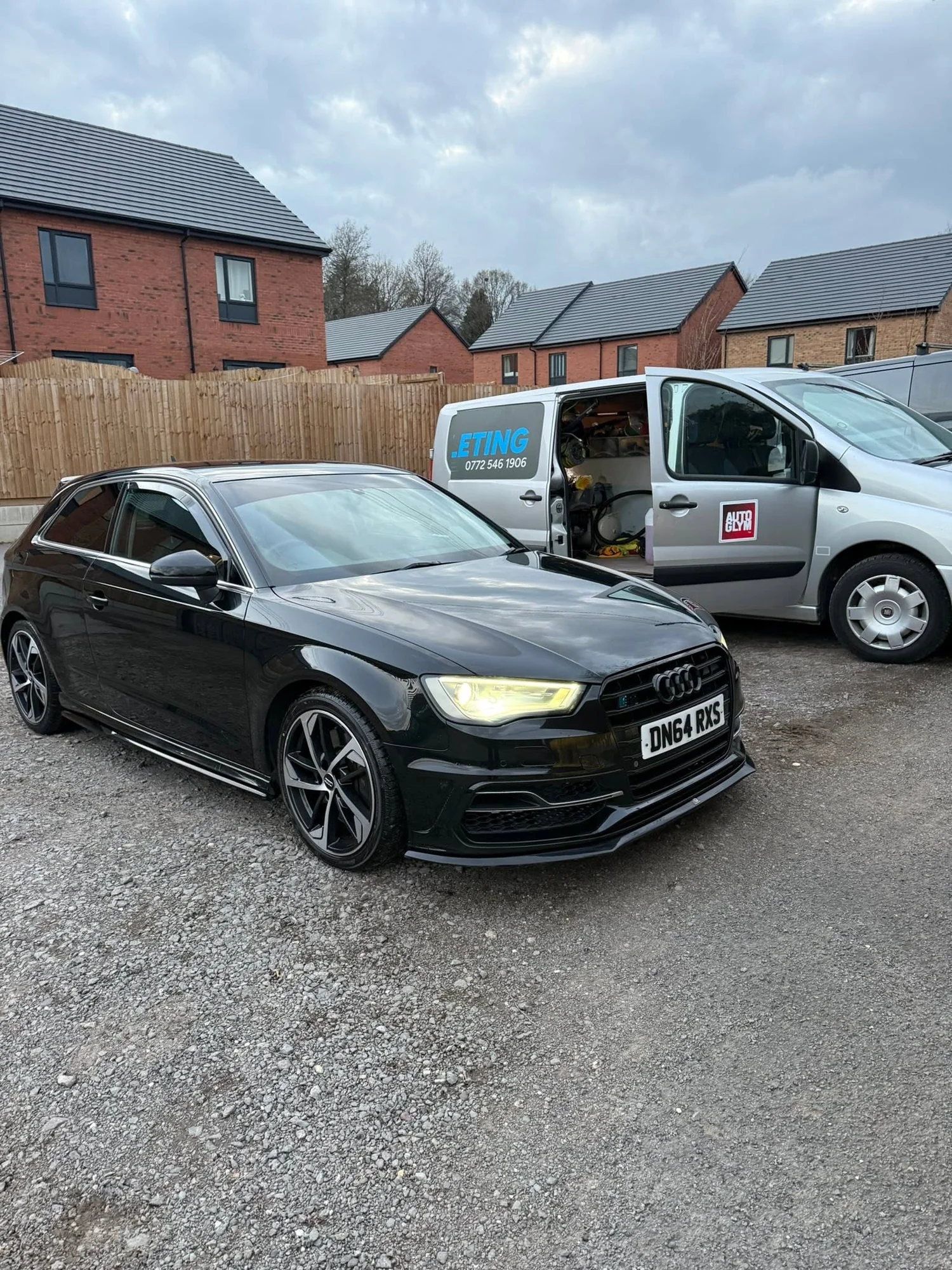 A clean black Audi beside the Crystal Mobile Car Valeting van