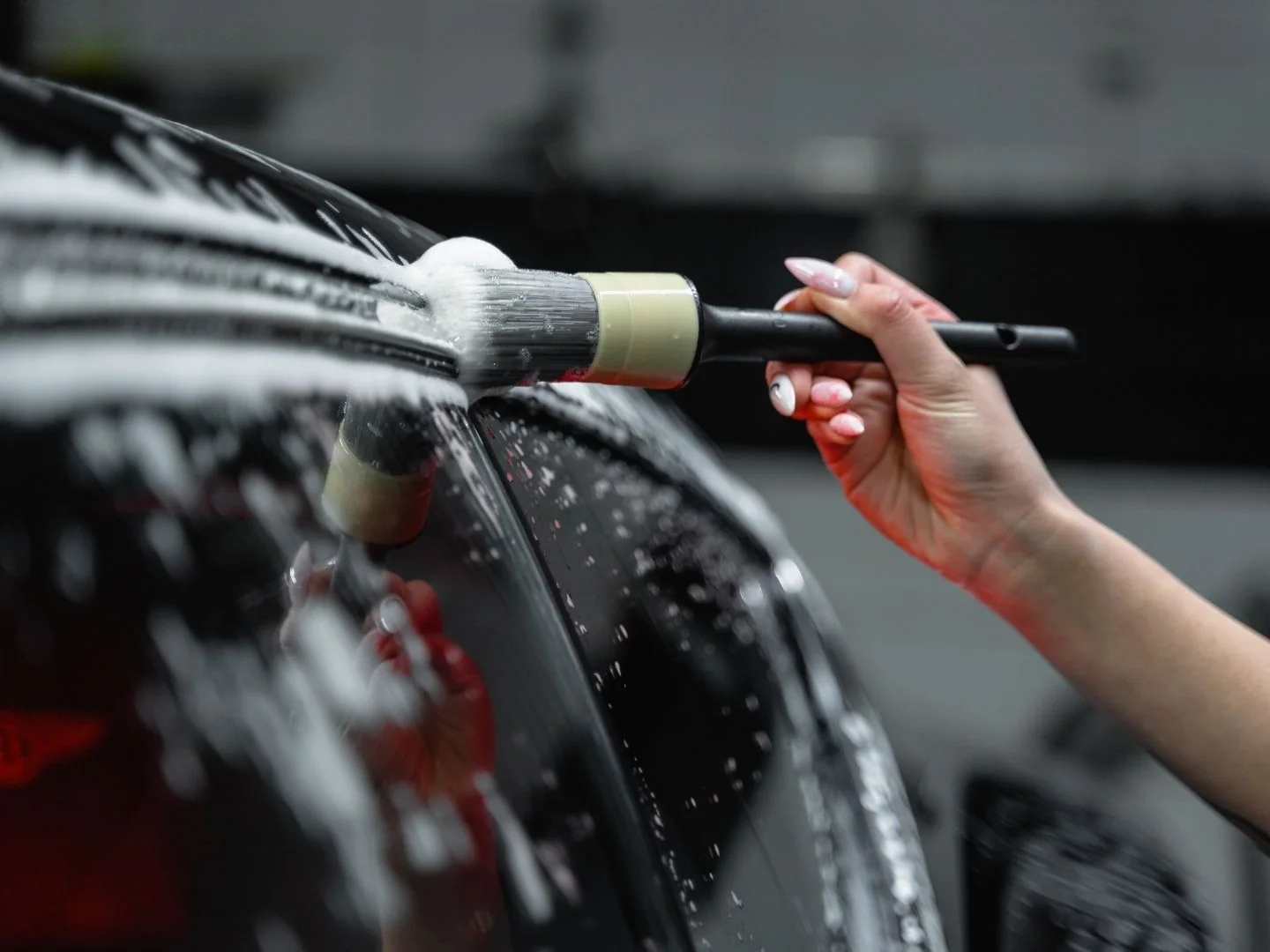 Detailing brush cleaning intricate exterior vehicle areas